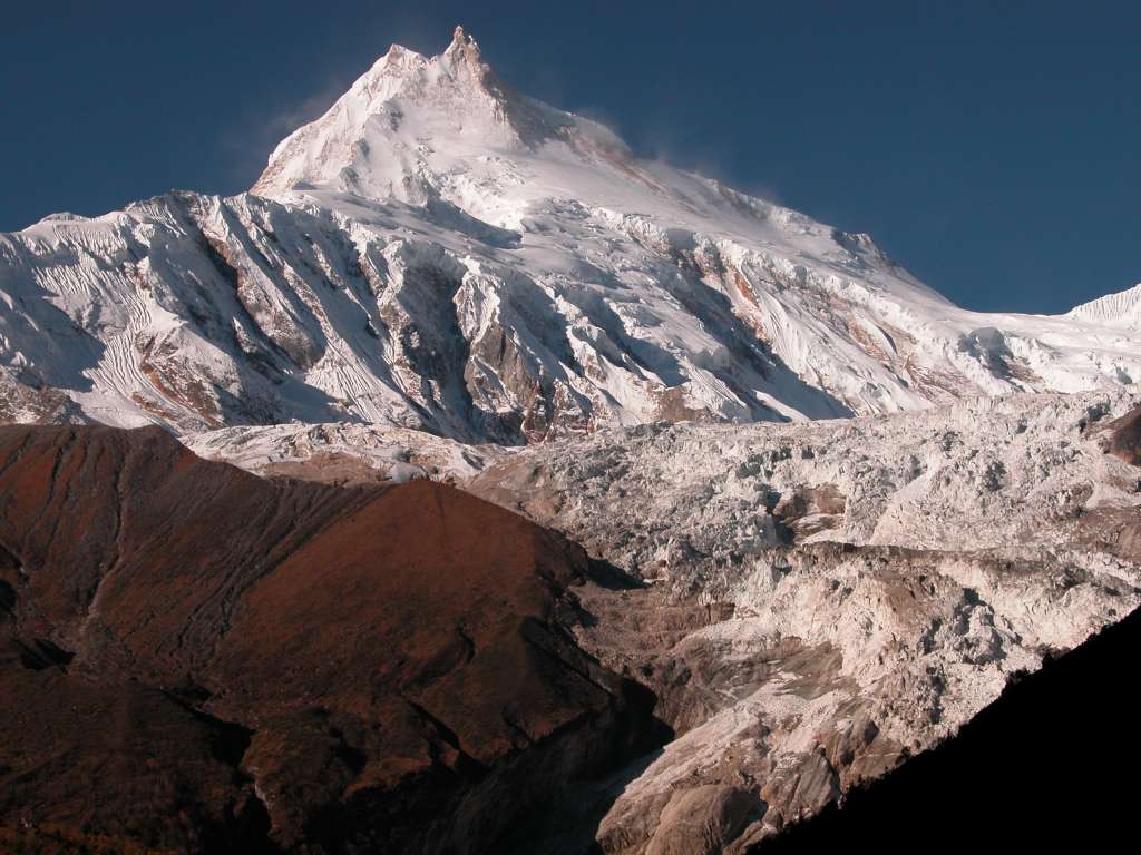 Manaslu 08 03 Manaslu Early Morning From Beyond Sama As I walked towards Samdo, I turned and caught another view of Manaslu with the Manaslu Icefall tumbling down. The normal climbing route is to the right of the glacier, and then up the long ridge going right to left.